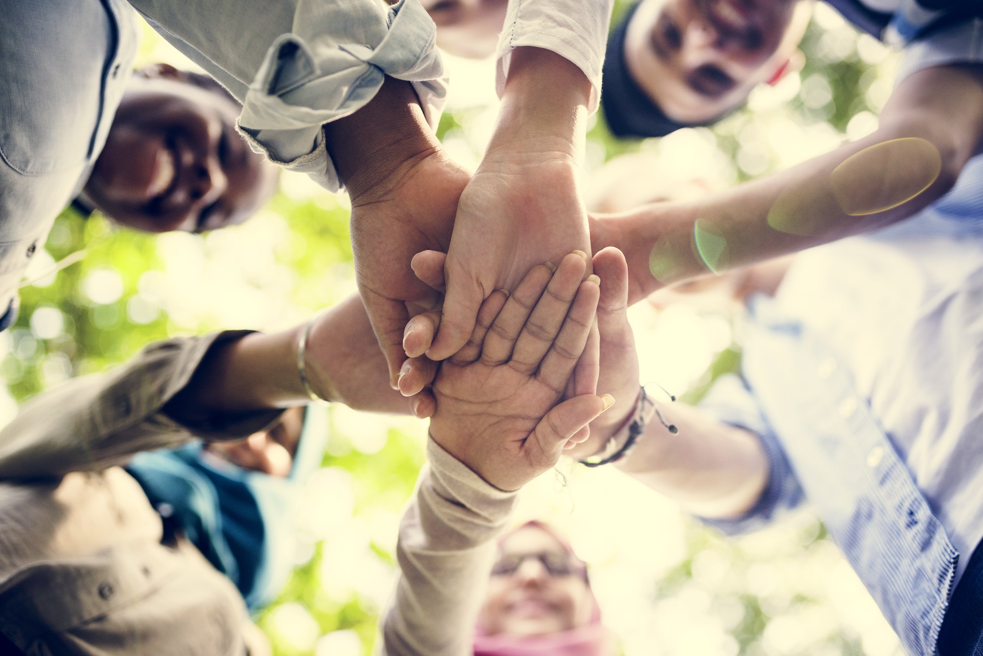 Group of diverse youth hands joined